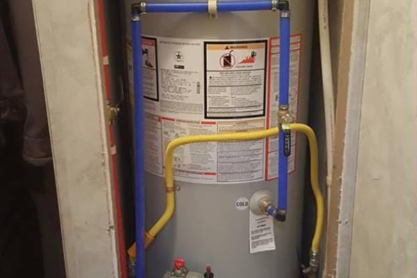 Compact water heater installation in a confined space by Applause Plumbing in Nazareth, PA. This specialized solution ensures safety and efficiency for small dwellings or trailers, optimizing space and providing reliable hot water supply.