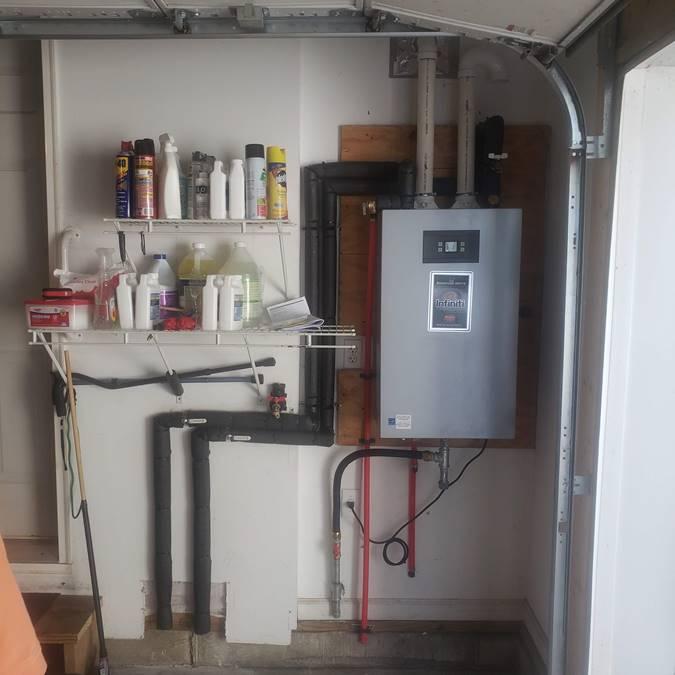 Tankless hot water heater installation by Applause Plumbing in Tatamy, PA. Optimizing space and energy efficiency, our service ensures a constant supply of hot water in garages. Expert insulation safeguards against temperature fluctuations, offering reliable and tailored solutions for your specific needs.