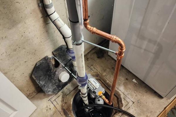 Water-powered backup sump pump installation by Applause Plumbing and Heating, featuring expert plumbing solutions. Learn about the benefits of water-powered sump pumps and ensure your home's safety with reliable plumbing solutions. The sump pump was installed in a customers basement in Easton, PA.