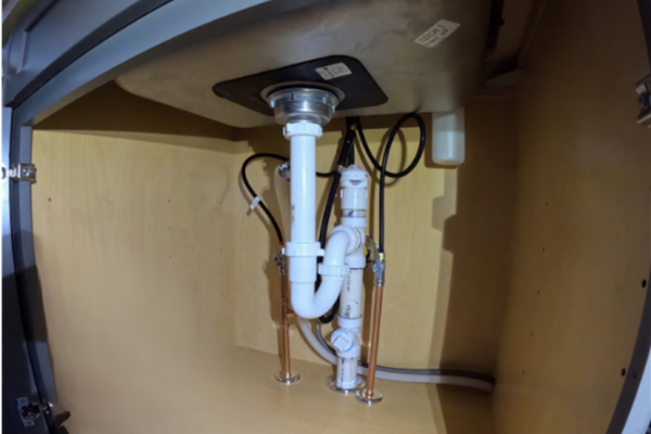 Newly installed kitchen sink drain line, expertly completed by Applause Plumbing and Heating in Stewartsville, NJ