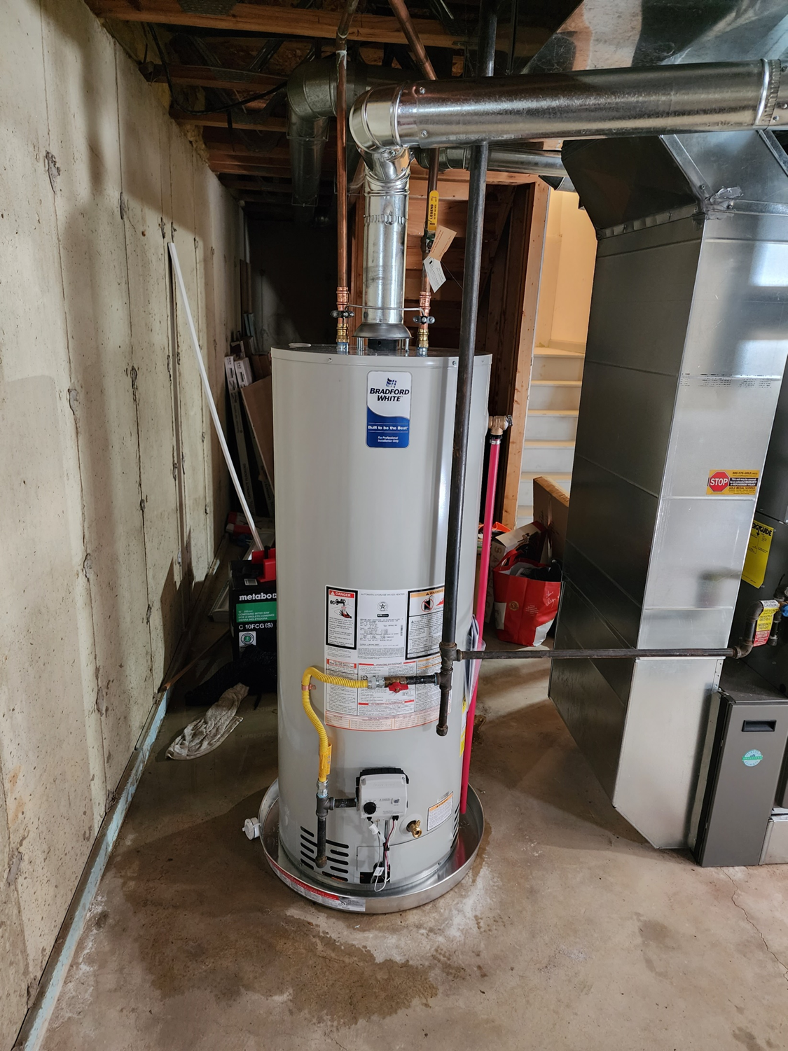 Efficient water heater replacement service by Applause Plumbing featuring a 50-gallon Bradford White unit with gas flex and chimney flue addition for optimal performance and safety. Expert plumbing solutions in action. The project was completed for a customer in Stewartsville, NJ.