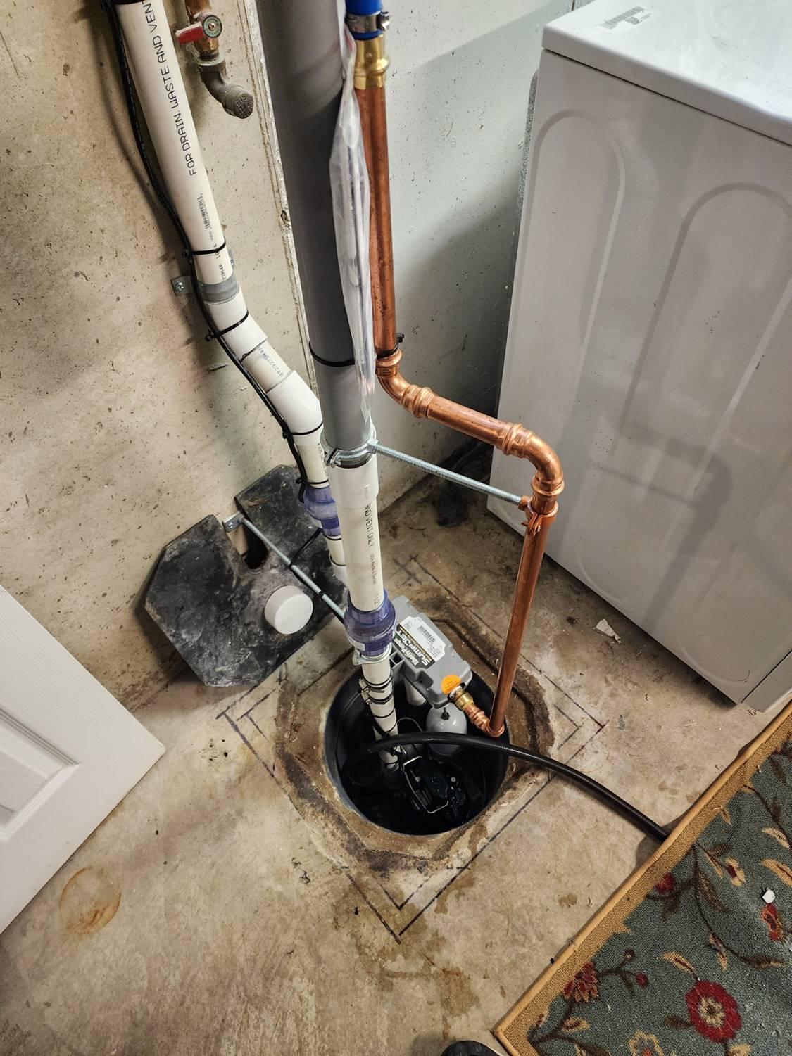 Water-powered backup sump pump installation by Applause Plumbing and Heating, featuring expert plumbing solutions. Learn about the benefits of water-powered sump pumps and ensure your home's safety with reliable plumbing solutions. The sump pump was installed in a customers basement in Easton, PA.