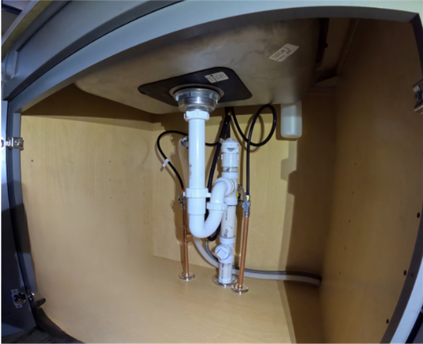 Newly installed kitchen sink drain line, expertly completed by Applause Plumbing and Heating in Stewartsville, NJ